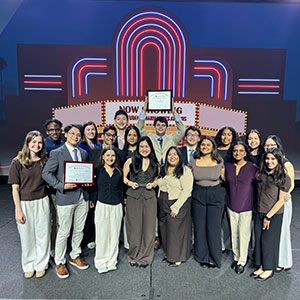 Group of about 18 APhA-ASP members at the APhA annual meeting, holding their certificate awards.