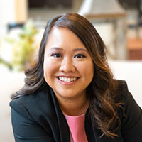 Deanna Tran posed outdoors wearing a dark blazer.