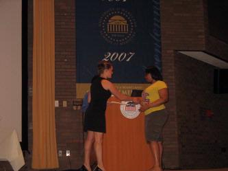 Christie Staso, ABAE historian, presents a certificate to high school student Taylor Washington.