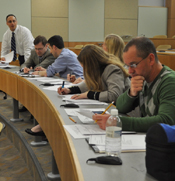 group of people near long desk writing