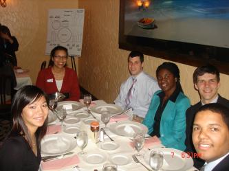 Students and a representative from Target (in the red shirt) enjoy dinner.