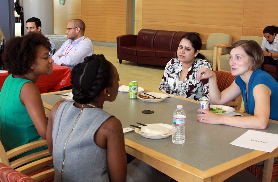 Dr. Lauren Hynicka speaks with students at faculty and student luncheon.