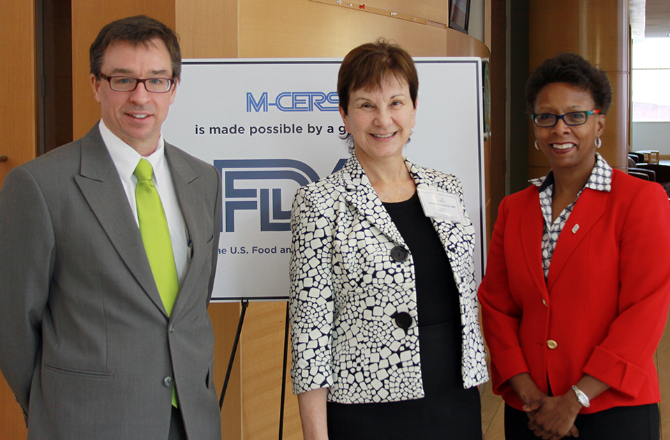 Standing Left to Right: James Polli, PhD; Janet Woodcock, MD; and Natalie Eddington, PhD, FCP, FAAPS