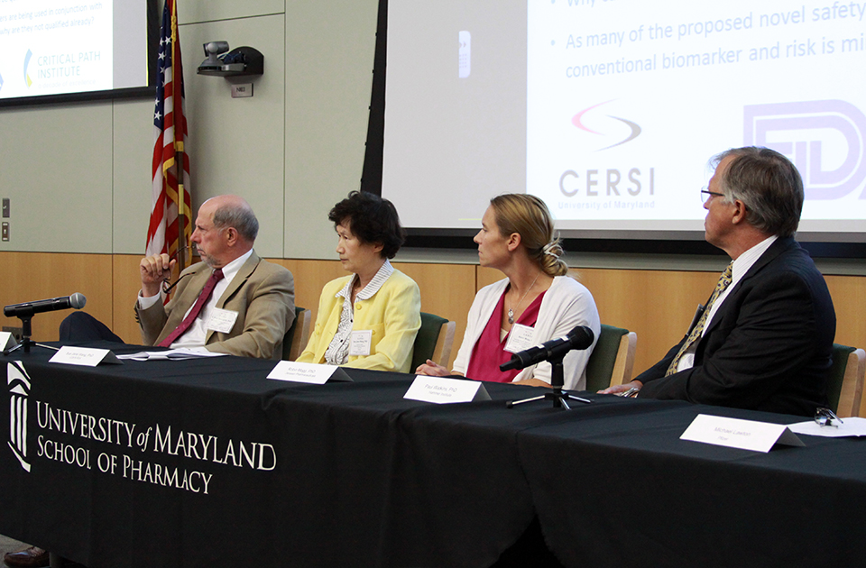 Three Panelists at CERSI Symposium on Biomarkers in Drug Development near desk