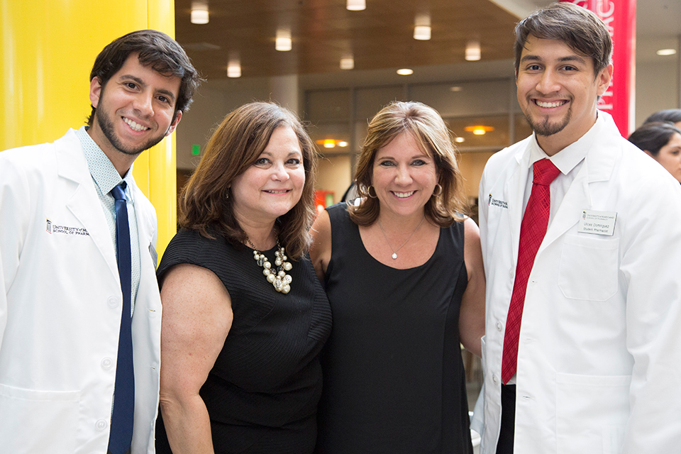 Faculty and students pose for photo during reception following White Coat Ceremony.
