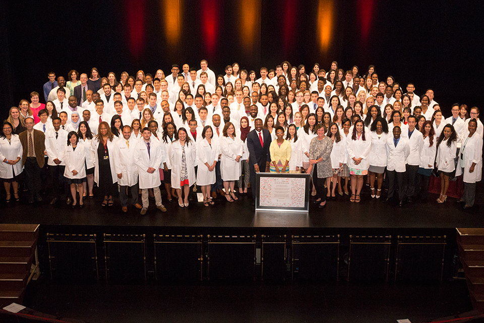 All faculty and students pose for group portrait following White Coat Ceremony.