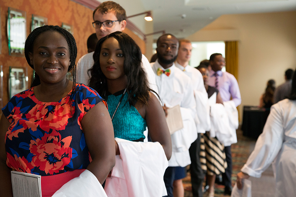 Students line up outside the theatre before the White Coat Ceremony.