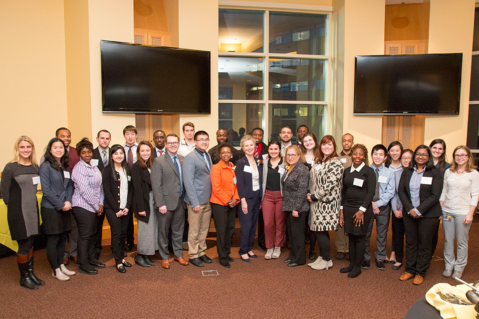 Attendees pose for group photo during scholarship reception.