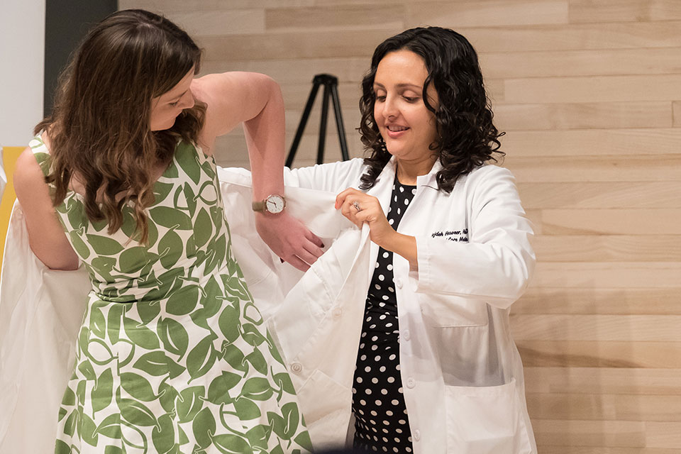 Student Dons White Coat with Assistance from Dr. Mojdeh Heavner