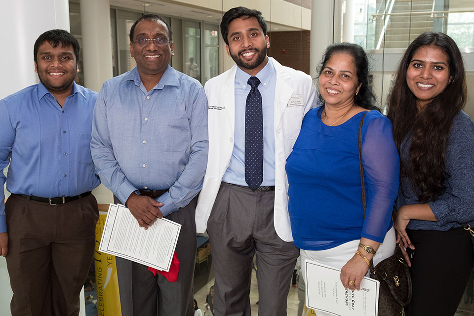 First-year Student Pictured with Family After Receiving White Coat