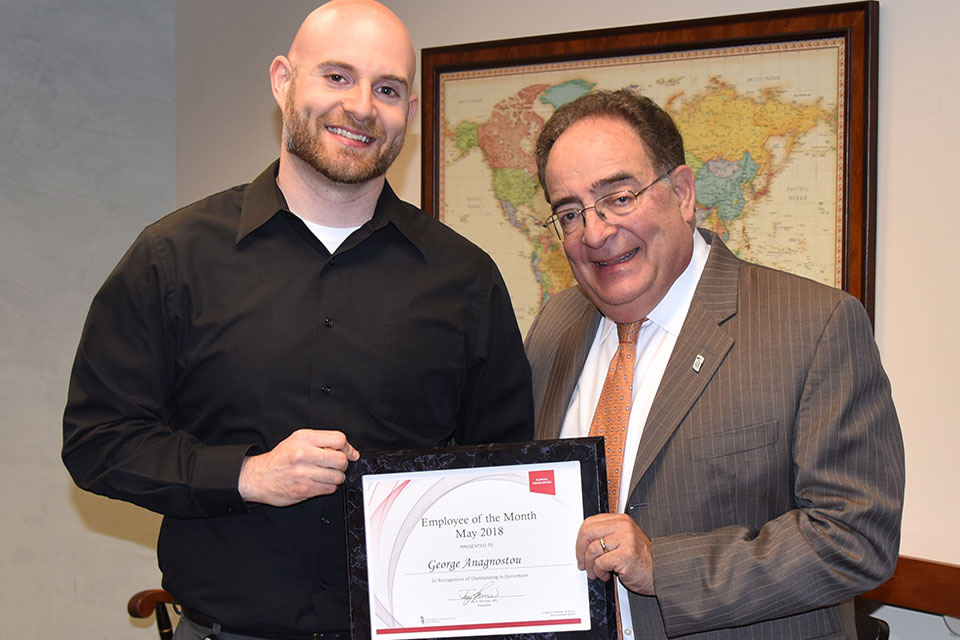 George Anagnostou (Left) pictured with UMB President Jay A. Perman, MD (Right).