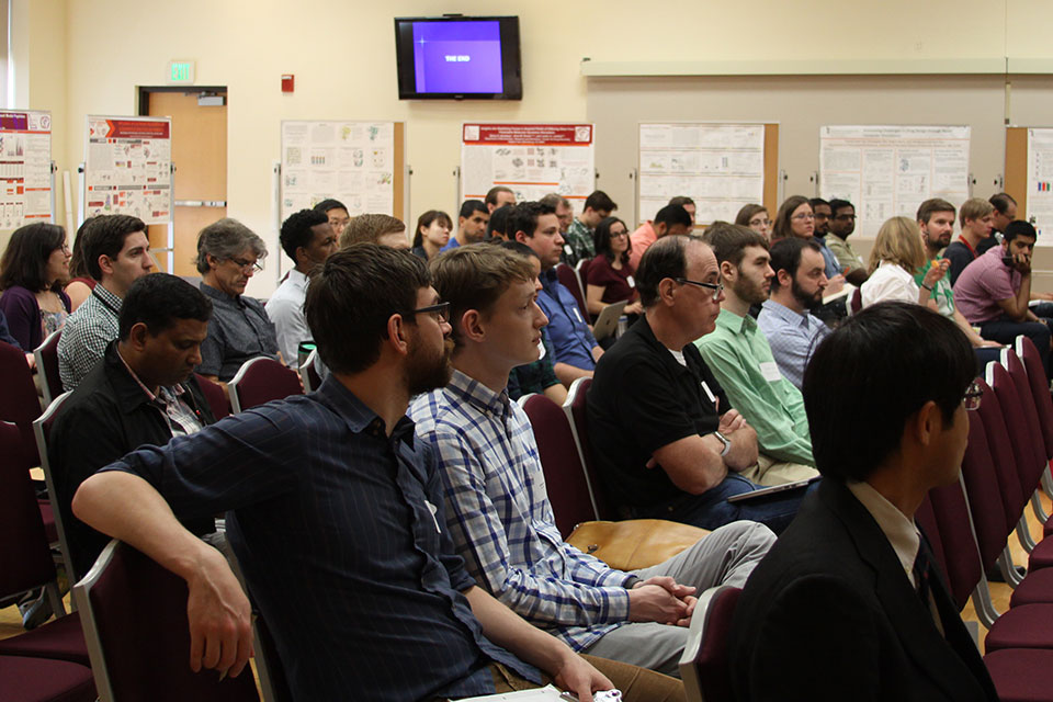 Audience members listen intently to presentations during the CADD Symposium.