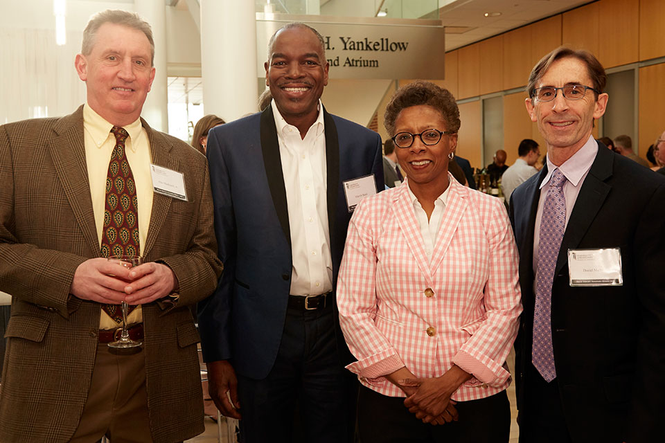 Dean Natalie Eddington pictured with Drs. Daniel Mullins and Alex MacKerell, as well as one of the School's donors.