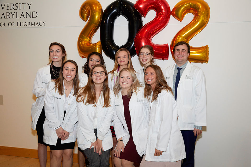 First-year student pharmacist Arissa Falat poses with friends in front of 