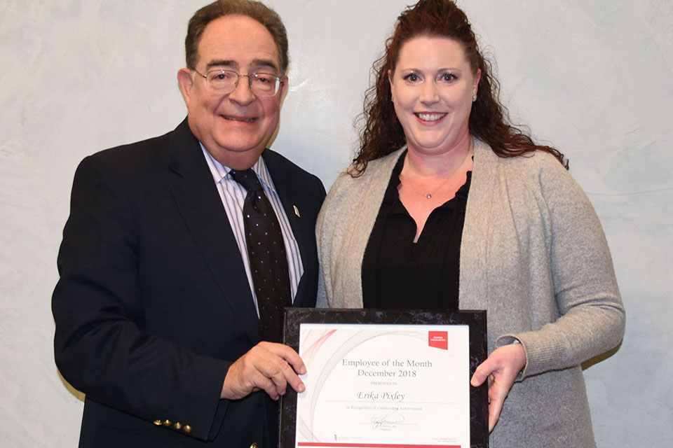 Erika Pixley, MBA, poses for photo with UMB President Jay A. Perman.