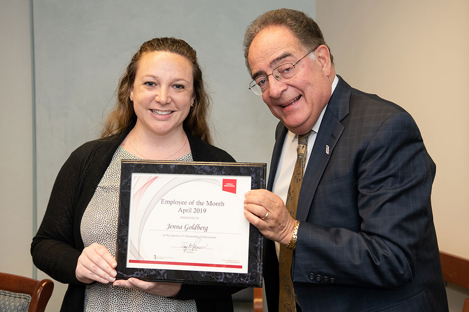 Jenna Goldberg poses for photo with UMB President Jay A. Perman, MD.