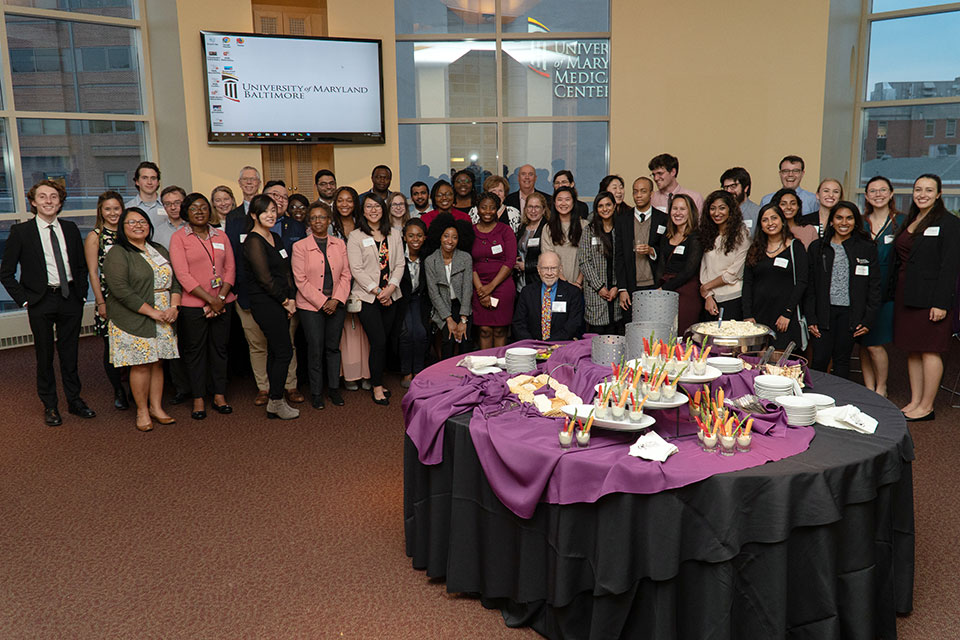 Scholarship donors and recipients who attended the reception pose for a photo in the Gladhill Boardroom.