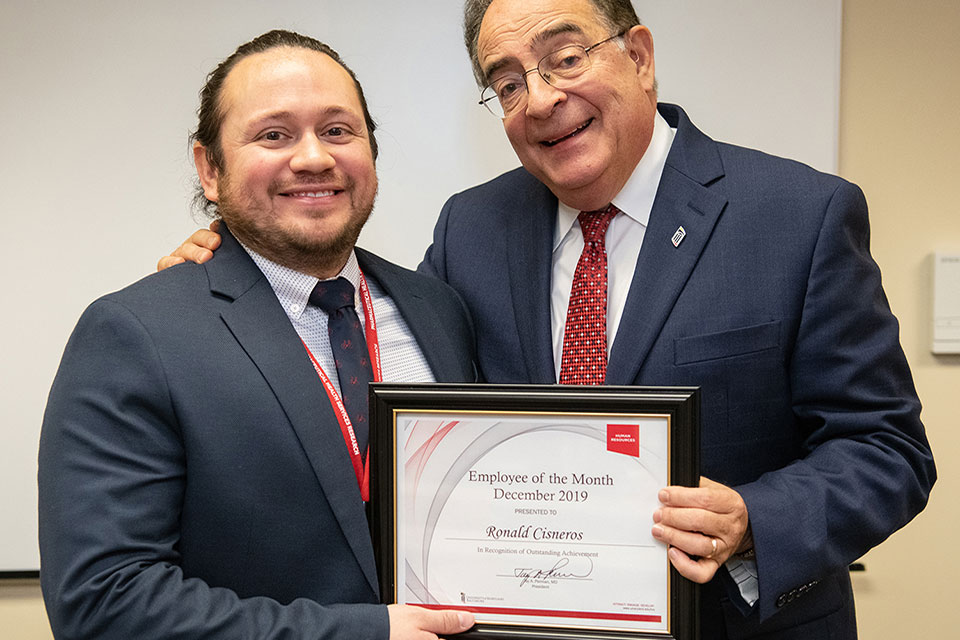 Ronald Cisneros poses for photo with Dr. Jay A. Perman.