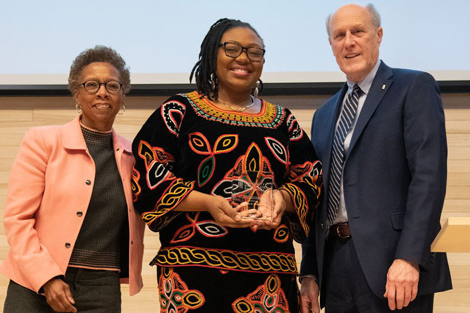 Fourth-year student pharmacist Elodie Tendoh poses for photo with Drs. Natalie Eddington and Bruce Jarrell after receiving her award.