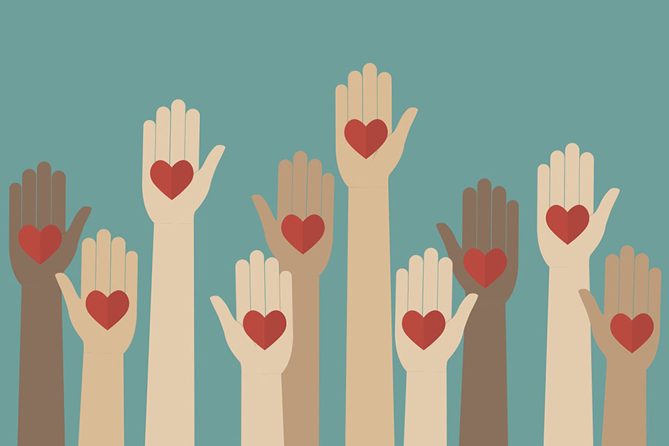 Raised hands with hearts in the center of each hand against a teal background.