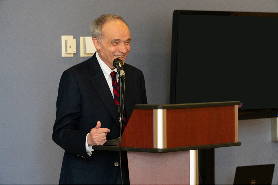 Frank Palumbo smiles while giving a speech.