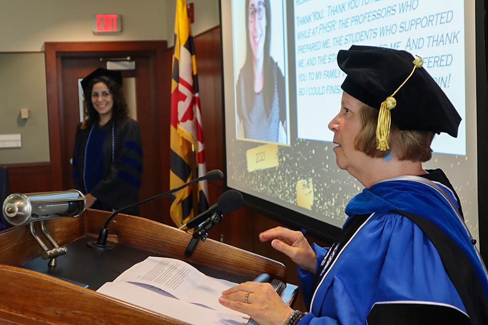 A PhD student listens as her faculty advisor speaks