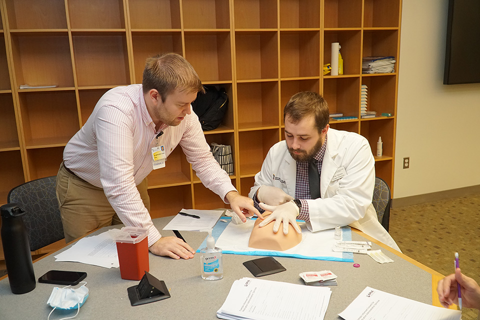 A student pharmacist receives instruction on how to administer long acting injectibles.