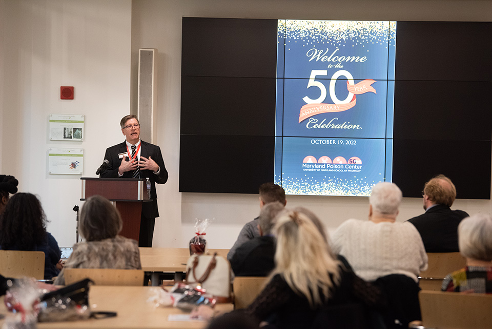Bruce Anderson speaks at the podium at the Maryland Poison Center's 50th anniversary.
