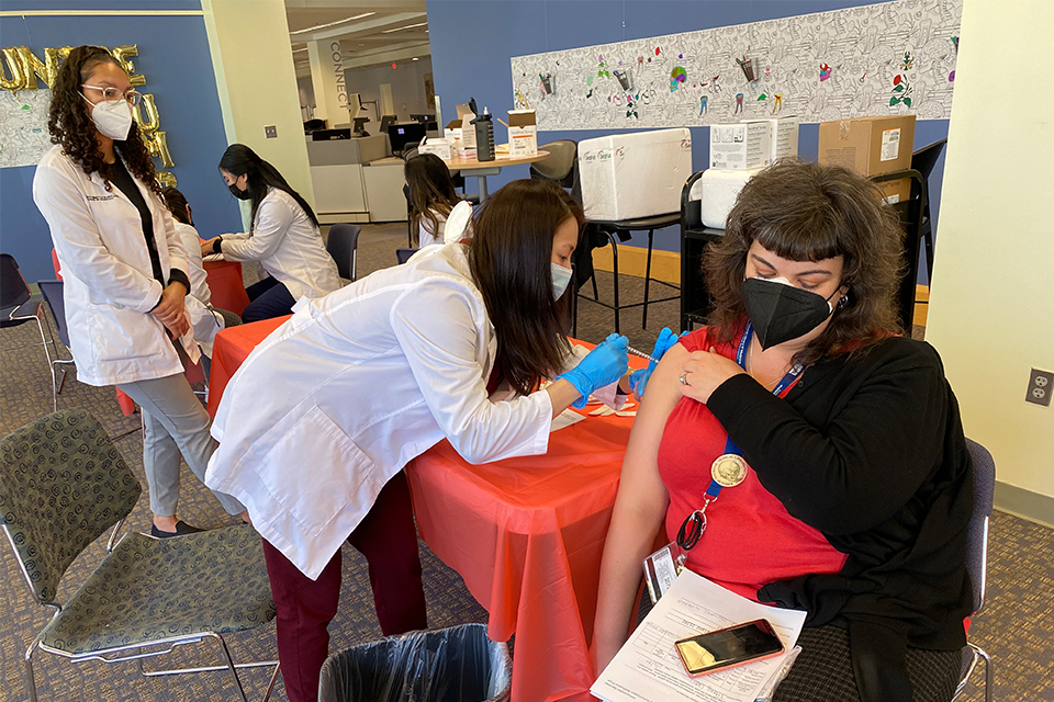 Fourth-year pharmacy student Katherine Tieu gives a vaccine during the Flu Clinic.
