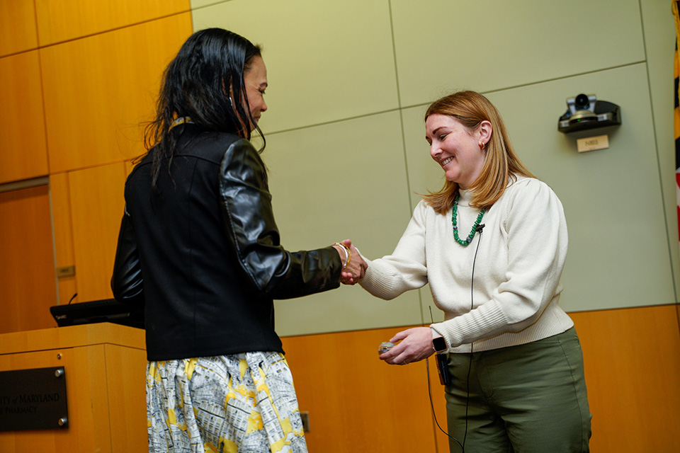 Leah Sera shakes the hand of a class of 2021 MCST graduate.