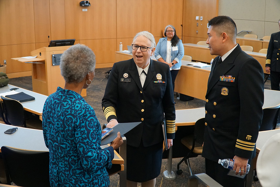 Rachel Levine greets Dean Natalie Eddington as Kinbo Lee watches.