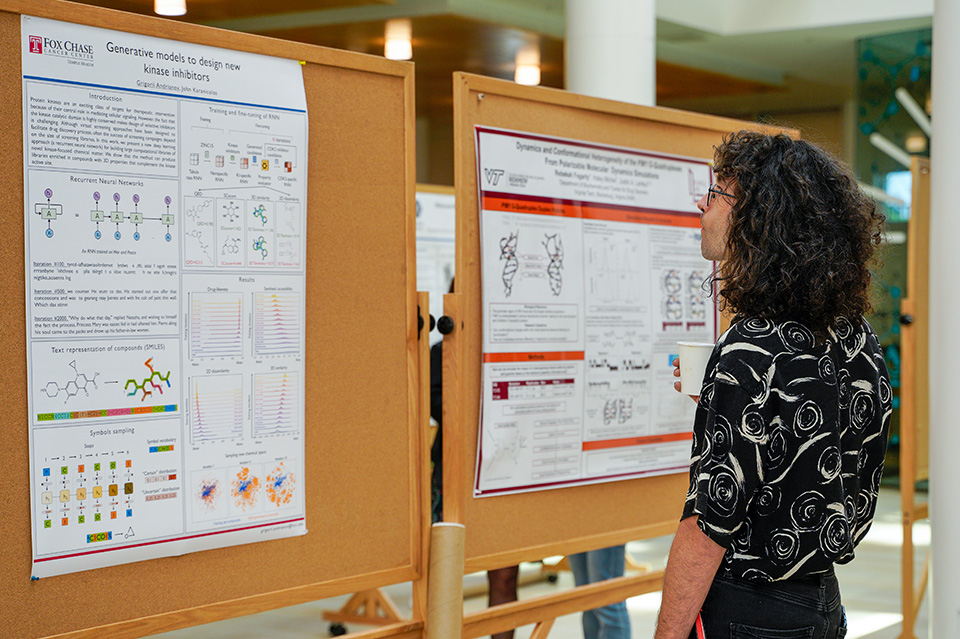 A person studies a poster at the CADD symposium.