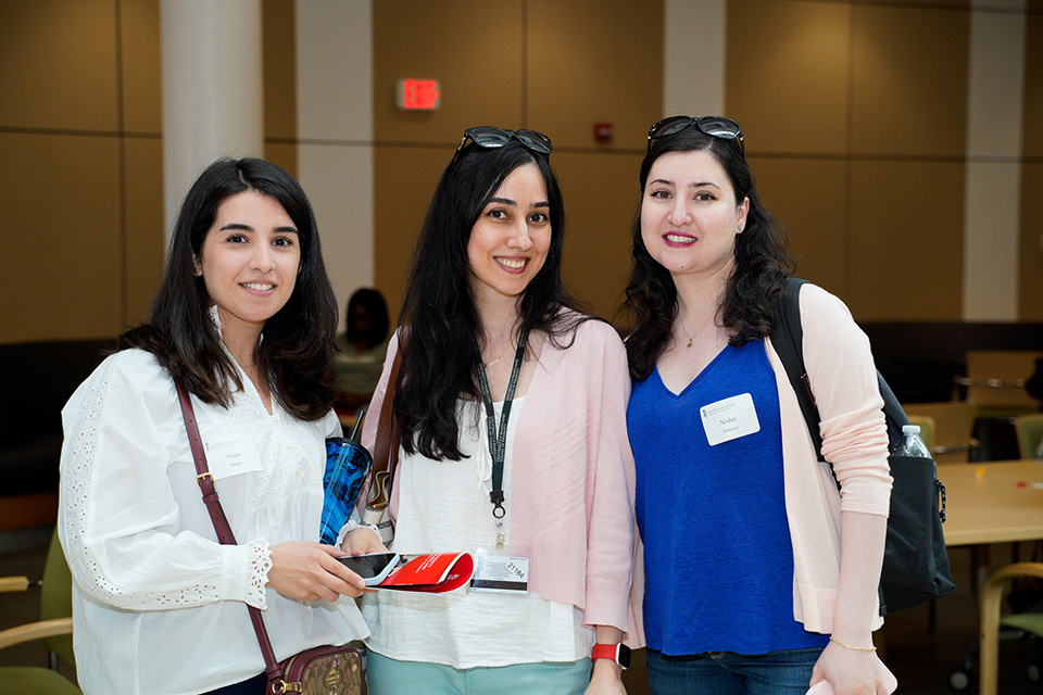 Incoming students stand together in the atrium.