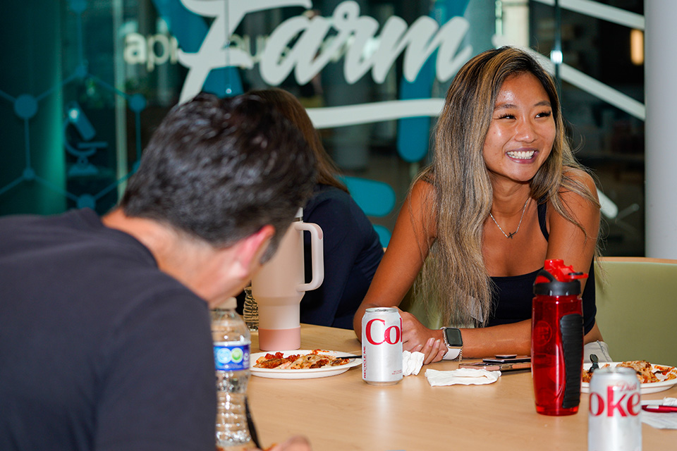 A student smiles in conversation at PharmD orientation.