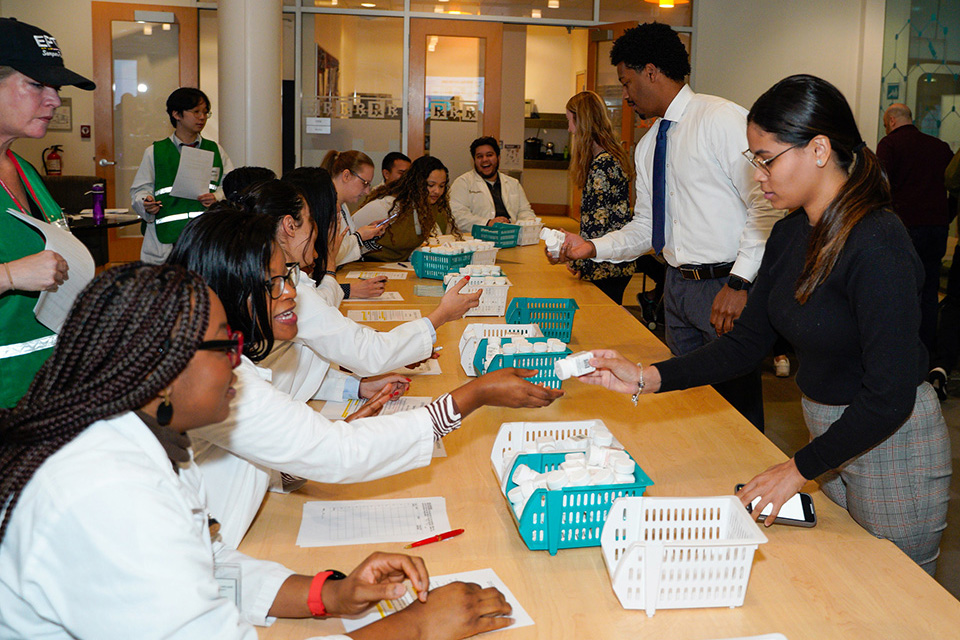Student pharmacists give out medication during the point of dispensing drill.