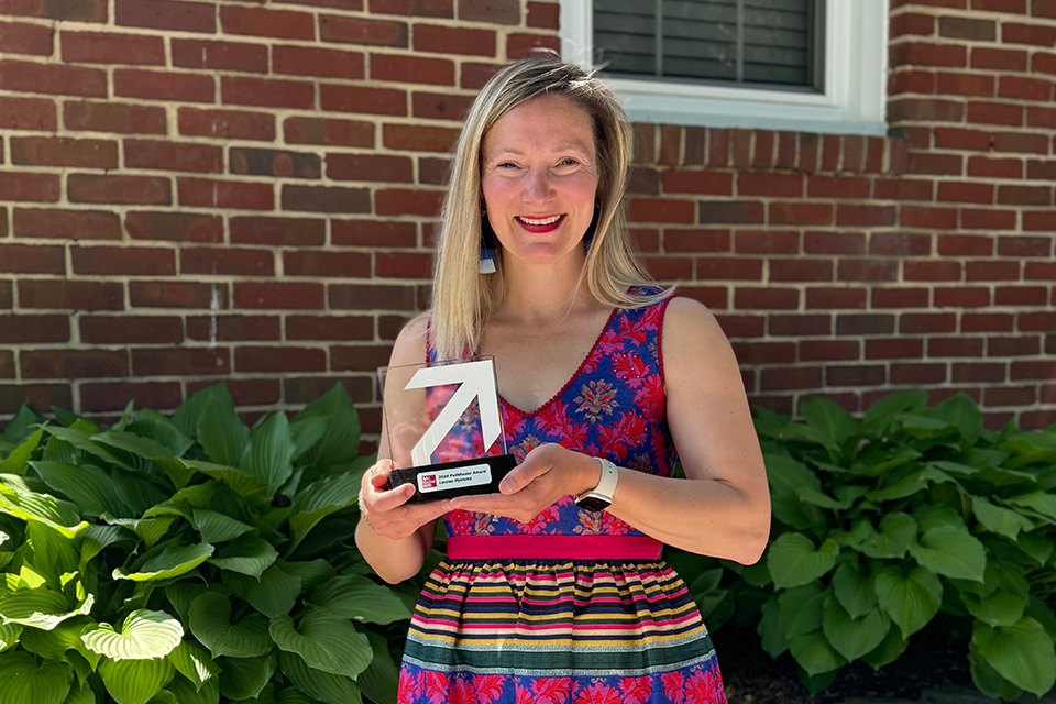 Lauren Hynicka holds an award.