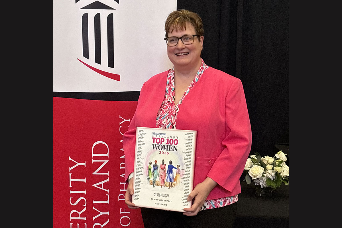 Jill Morgan poses holding a Maryland’s Top 100 Women 2026 award plaque.