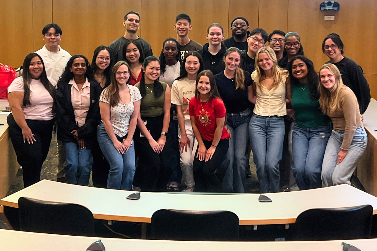 APhA‑ASP student leaders pose together in a lecture hall.